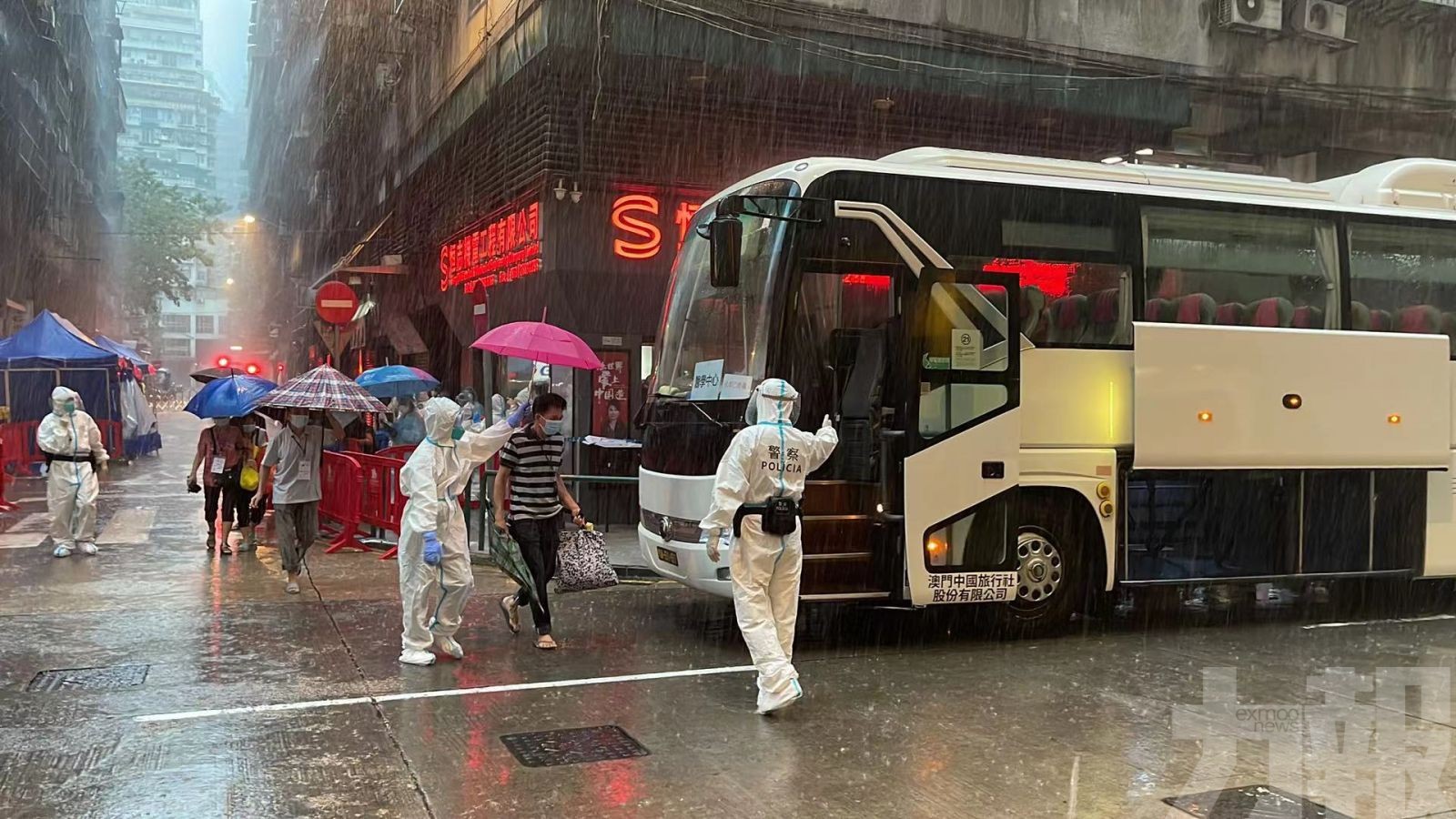 雨中被分批送往醫觀酒店隔離